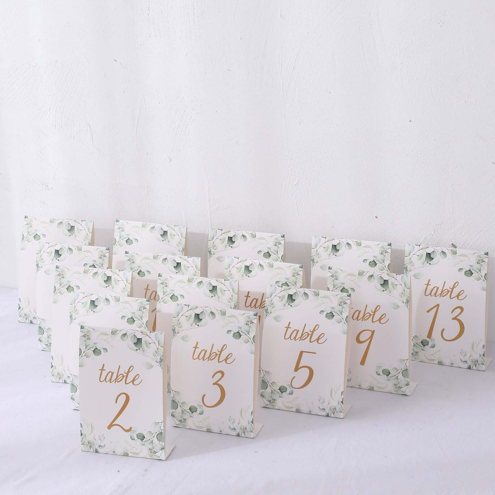 25-Pack Paper Wedding Table Numbers 1-25 White/Green Eucalyptus Leaves Design - Free Standing Double Sided Table Signs with Glam Gold Foil Numbers 7