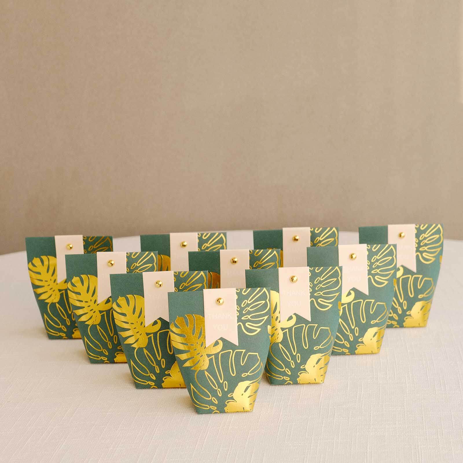 25 Pack Hunter Emerald Green Paper Pouch Candy Gift Bags With Gold Monstera Leaves Print, Party Favor Boxes with Pin and Tags - 4.5x4